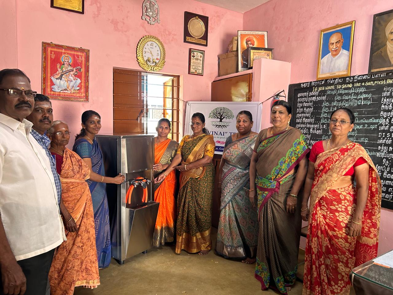 Water dispenser with staff and community members